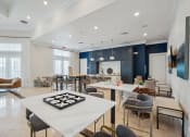 Thumbnail 20 of 48 - a communal area with tables and chairs and a kitchen and living room