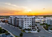 Thumbnail 2 of 27 - A sunset view of a street with cars and buildings.at Icon One, Daytona Beach, 32114