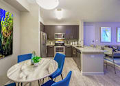 Thumbnail 22 of 27 - a kitchen and dining room with a table and chairs at Icon One, Florida, 32114