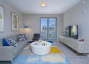 Thumbnail 9 of 27 - a living room with a couch and a coffee table and a tv at Icon One, Florida, 32114