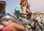 Thumbnail 17 of 48 - a group of people riding bikes on the beach at The Falls of Portofino, Naples