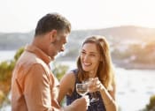 Thumbnail 34 of 48 - a man and a woman holding a glass of wine