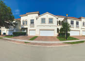Thumbnail 26 of 48 - a large white house on the corner of a street at The Falls of Portofino, Naples, FL, 34119