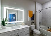 Thumbnail 23 of 27 - A bathroom with a white sink, toilet, and bathtub.at Icon One, Daytona Beach, Florida