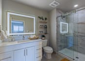 Thumbnail 12 of 27 - A bathroom with a marble tile shower and a white toilet.at Icon One, Daytona Beach, FL, 32114