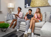 Thumbnail 9 of 24 - Three people are sitting on a couch at Portofino Cove, Fort Myers, Florida