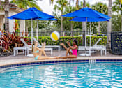 Thumbnail 5 of 24 - Two women sunbathing by a pool at Portofino Cove, Fort Myers, FL