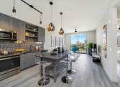 Thumbnail 13 of 23 - Kitchen And Living Room at Quantum Apartments, Fort Lauderdale, FL, 33304