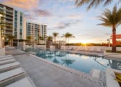 Thumbnail 3 of 23 - Sunset on The Bridge at Quantum Apartments palm lined pool deck
