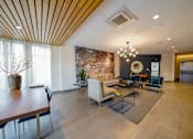 Thumbnail 17 of 72 - A modern living room with a wooden ceiling and a large painting on the wall.
