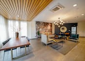 Thumbnail 15 of 73 - A modern dining room with a wooden table and chairs.