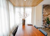 Thumbnail 20 of 72 - A long wooden table with a vase of dried flowers on it.