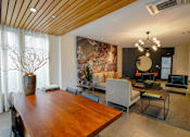 Thumbnail 19 of 72 - A modern dining room with a wooden table and chairs.