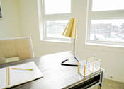 Thumbnail 66 of 72 - A table with a lamp, a notebook and a pencil on it.