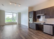 Thumbnail 52 of 72 - A kitchen with dark wood cabinets and a white countertop.