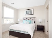 Thumbnail 62 of 72 - A bedroom with a large bed and a picture frame on the wall.