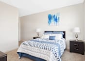 Thumbnail 61 of 72 - A bedroom with a bed, nightstands, and a painting on the wall.