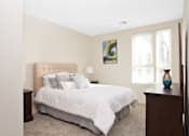 Thumbnail 56 of 72 - A bedroom with a large bed and a painting on the wall.