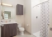 Thumbnail 54 of 72 - A bathroom with a toilet, sink, and shower.