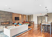 Thumbnail 12 of 72 - A modern living room with a fireplace and a dining area.