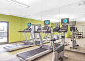 Thumbnail 35 of 72 - A gym with treadmills and exercise equipment.