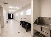 Thumbnail 7 of 24 - A clean, empty hallway with a stainless steel oven on the right.
