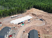 Thumbnail 10 of 20 - A construction site with a large open area and a few buildings.