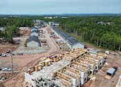 Thumbnail 13 of 20 - A construction site with a building under construction surrounded by trees.