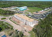 Thumbnail 1 of 24 - an aerial view of a building with a construction site and a parking lot