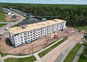 Thumbnail 2 of 24 - an aerial view of a building being constructed next to a road