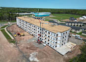 Thumbnail 4 of 24 - an aerial view of a large building under construction with a crane