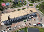 Thumbnail 3 of 24 - an aerial view of a building being constructed next to a road