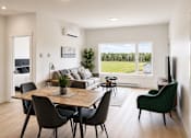 Thumbnail 17 of 24 - A modern dining room with a wooden table and chairs.
