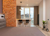 Thumbnail 13 of 15 - A room with a brick wall and a grey carpet.