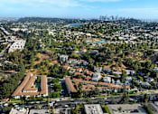 Thumbnail 1 of 12 - A bird's eye view of a city with a large building in the foreground.