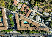 Thumbnail 2 of 12 - A bird's eye view of a residential area with houses and cars.