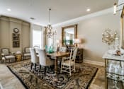 Thumbnail 10 of 21 - A dining room with a table set for six.