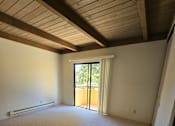 Thumbnail 22 of 41 - an empty living room with a sliding glass door to a patio
