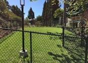 Thumbnail 22 of 31 - a yard with a chain link fence and a baseball field