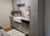 Thumbnail 14 of 31 - a kitchen with stainless steel appliances and a white sink