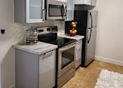 Thumbnail 12 of 31 - a kitchen with stainless steel appliances and white cabinets