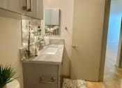 Thumbnail 11 of 31 - a small bathroom with a sink and a shower