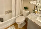 Thumbnail 9 of 31 - a small bathroom with a toilet and a bath tub