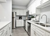Thumbnail 2 of 26 - kitchen with all white cabinets, stainless steel appliances and breakfast bar