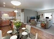 Thumbnail 4 of 25 - A modern kitchen with a dining table set for four.