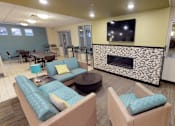 Thumbnail 10 of 25 - A living room with a fireplace and a television.