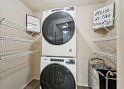 Thumbnail 3 of 31 - Laundry Room with front loading washer and dryer at The Bosk Apartment Homes, Minnesota, 55125