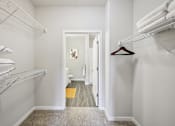 Thumbnail 9 of 49 - A hallway with white walls and a carpeted floor.