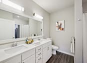 Thumbnail 10 of 49 - A white bathroom with a white sink and a white toilet.