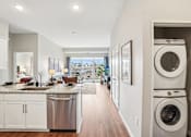 Thumbnail 14 of 42 - A modern kitchen with a view of the balcony.